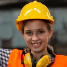 Technician in a yellow hard hat and ear defenders