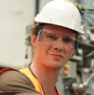 Technician wearing a white hard hat and safety glasses